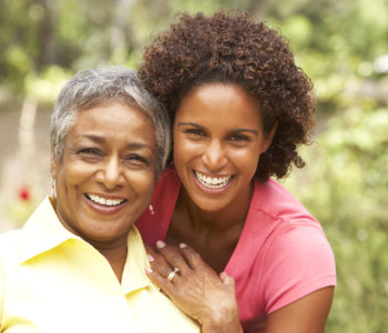 elderly woman and caregiver smiling