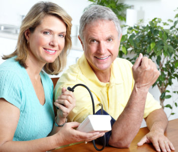 caregiver and elderly man smiling