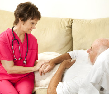 caregiver assisting elderly man