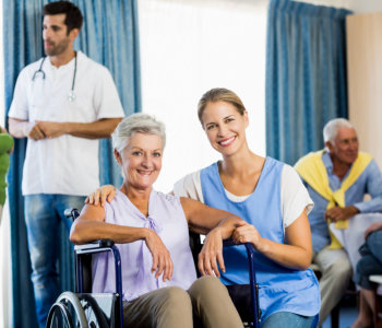 caregiver and elderly woman smiling